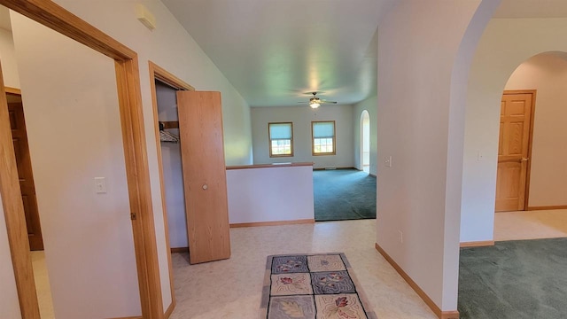 corridor featuring light colored carpet