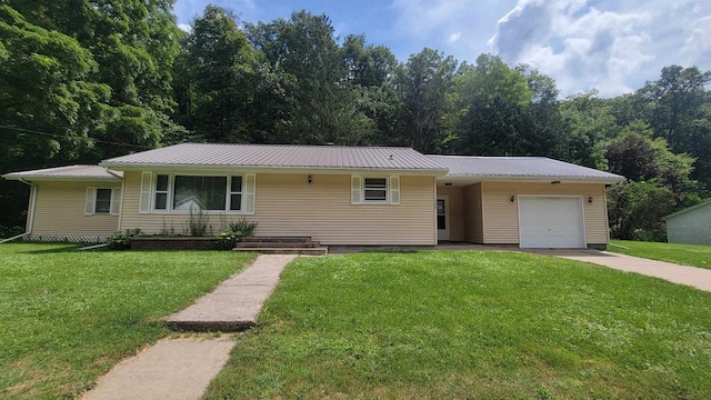 ranch-style home featuring metal roof, concrete driveway, a front lawn, and an attached garage