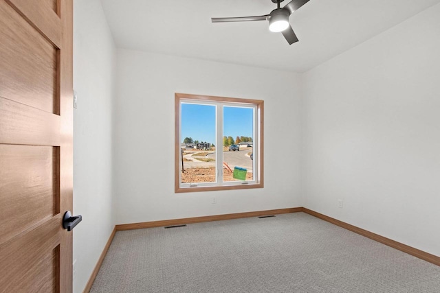 unfurnished room featuring carpet, visible vents, ceiling fan, and baseboards