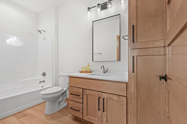 bathroom with bathtub / shower combination, vanity, toilet, and wood finished floors