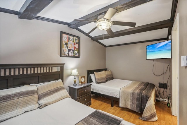 bedroom featuring beam ceiling, a ceiling fan, wood finished floors, and ornamental molding