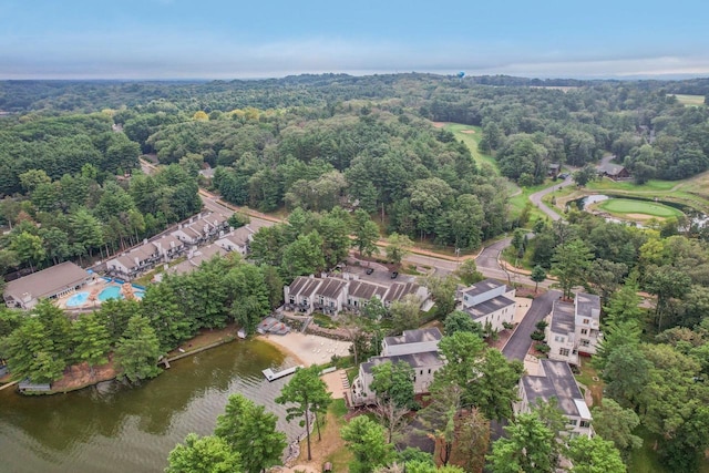 drone / aerial view with a water view and a wooded view