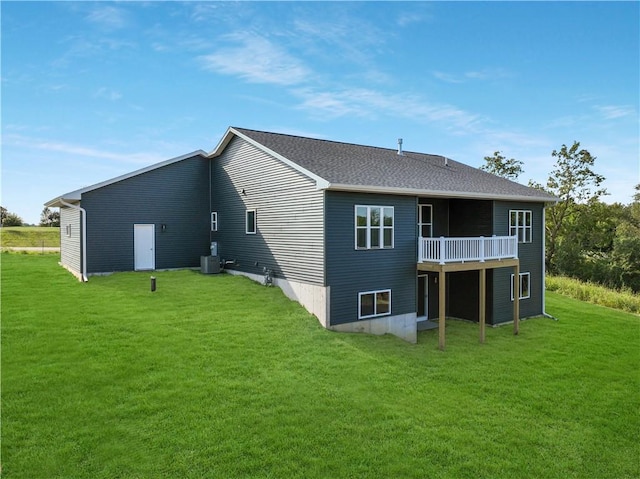 back of house featuring a yard and central AC