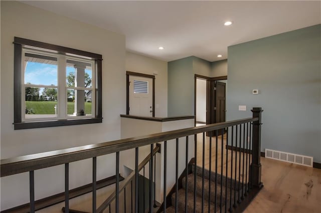 hall with hardwood / wood-style flooring