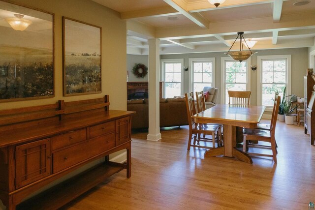 dining space featuring light hardwood / wood-style floors, ornate columns, beamed ceiling, and coffered ceiling