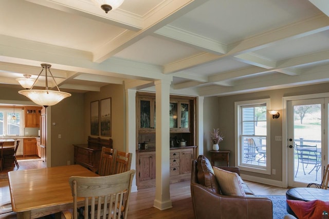 dining area with coffered ceiling, beamed ceiling, and hardwood / wood-style floors