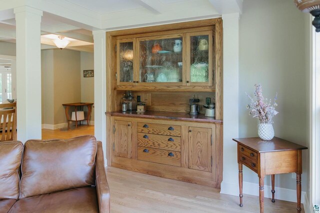 34780 S County Highway J, Bayfield, WI 54814 - bar with light wood-type flooring, baseboards, and ornate columns