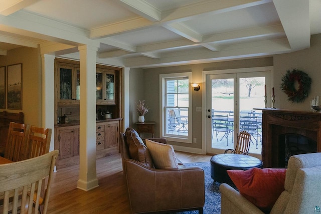 living room with hardwood / wood-style floors, beam ceiling, decorative columns, and coffered ceiling