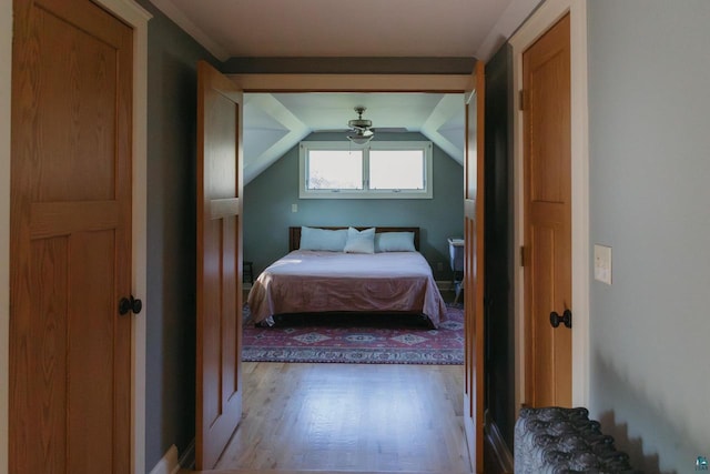 bedroom with light hardwood / wood-style flooring and lofted ceiling