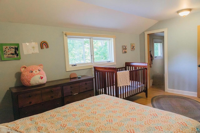 bedroom featuring vaulted ceiling and light hardwood / wood-style floors