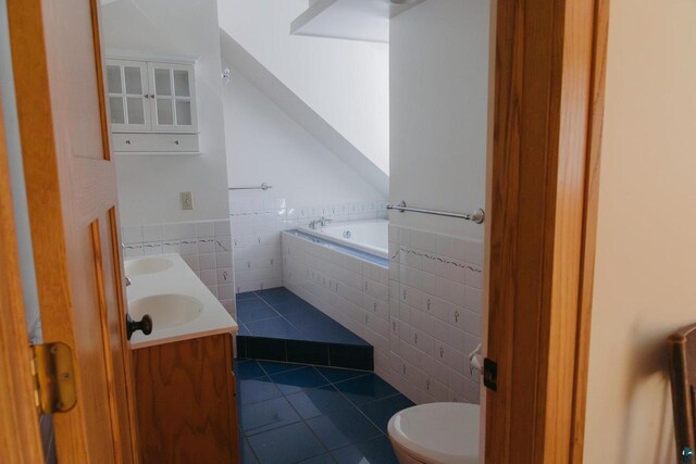 34780 S County Highway J, Bayfield, WI 54814 - full bath featuring double vanity, tile walls, tile patterned floors, a garden tub, and a sink