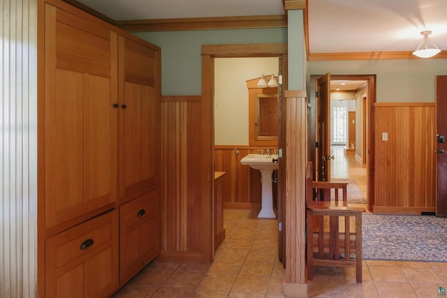 34780 S County Highway J, Bayfield, WI 54814 - hall with light tile patterned flooring, a wainscoted wall, wood walls, a sink, and crown molding