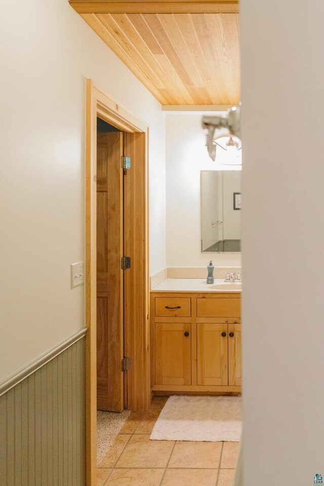 bathroom featuring wood ceiling, tile patterned floors, and vanity