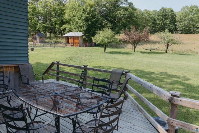 wooden terrace featuring a lawn