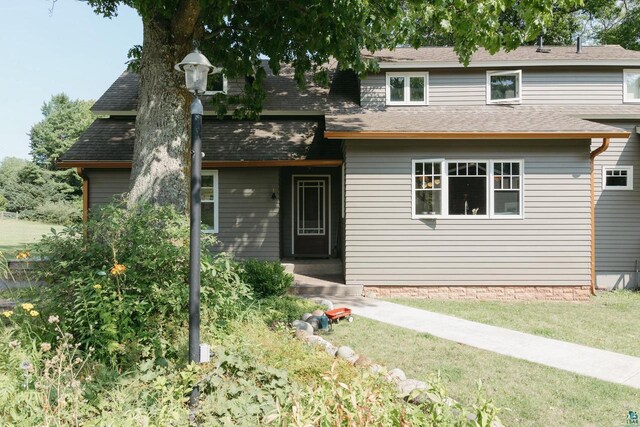 34780 S County Highway J, Bayfield, WI 54814 - view of front of house with a shingled roof and a front lawn