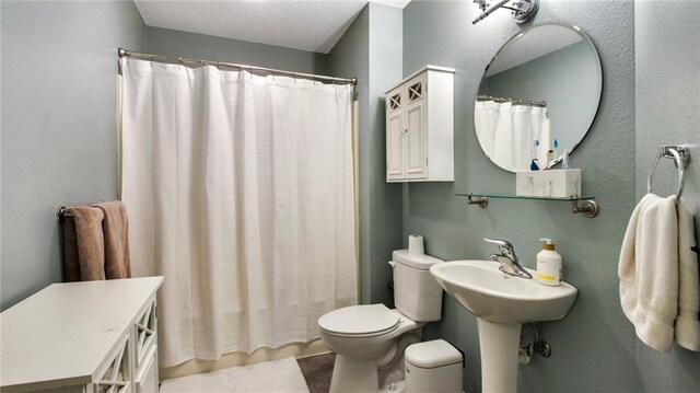 bathroom with curtained shower and toilet