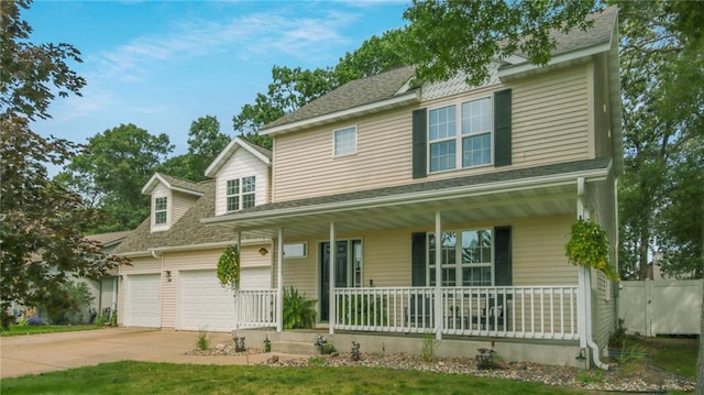 view of front facade featuring a porch, driveway, and fence