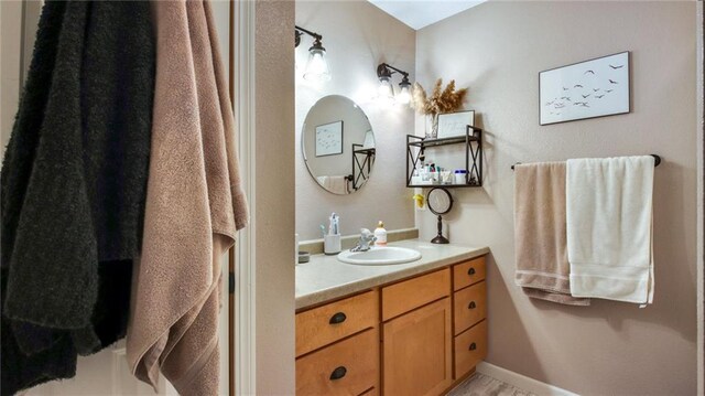 bathroom with vanity and baseboards