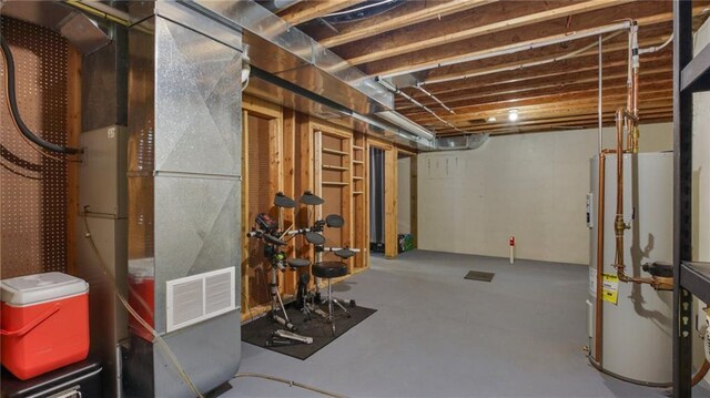 basement featuring gas water heater and heating unit