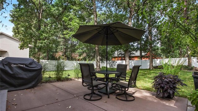 view of patio / terrace featuring a fenced backyard, a grill, and outdoor dining space