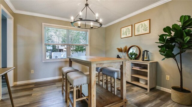 dining area with crown molding, an inviting chandelier, and dark hardwood / wood-style floors