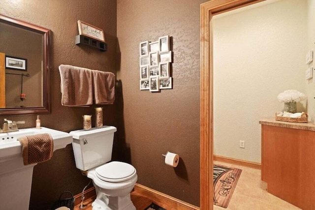 bathroom with toilet and tile patterned floors