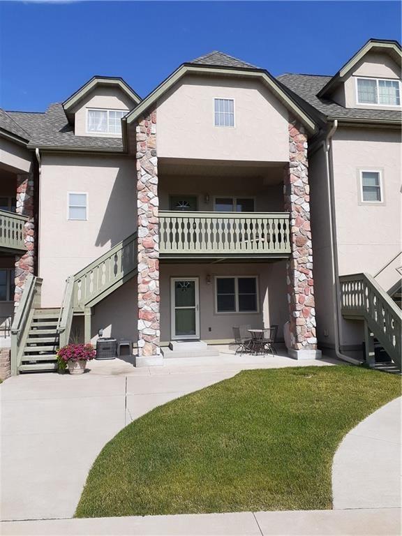 exterior space with a lawn and a balcony