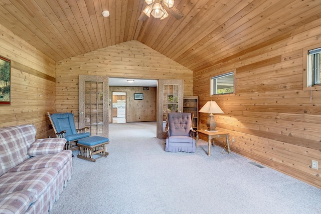 sitting room featuring visible vents, wooden walls, wooden ceiling, carpet flooring, and lofted ceiling