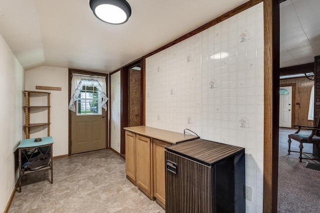 interior space featuring lofted ceiling and baseboards