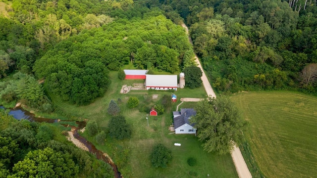 birds eye view of property featuring a wooded view