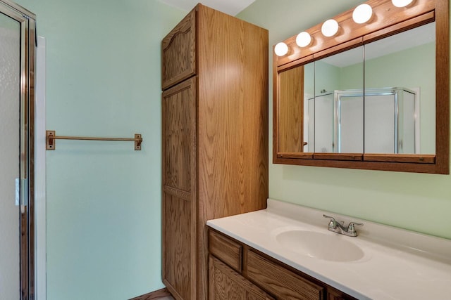 bathroom featuring vanity and a shower stall