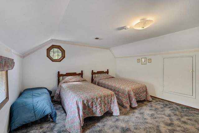 carpeted bedroom featuring visible vents and vaulted ceiling