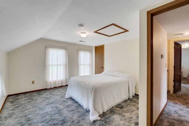 carpeted bedroom featuring visible vents, baseboards, and vaulted ceiling