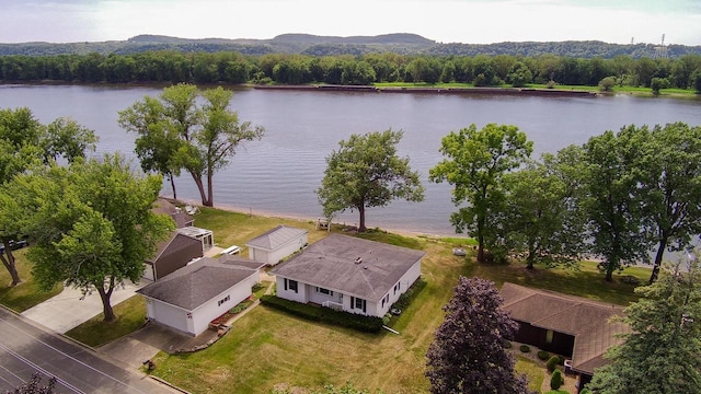 birds eye view of property featuring a water view and a view of trees