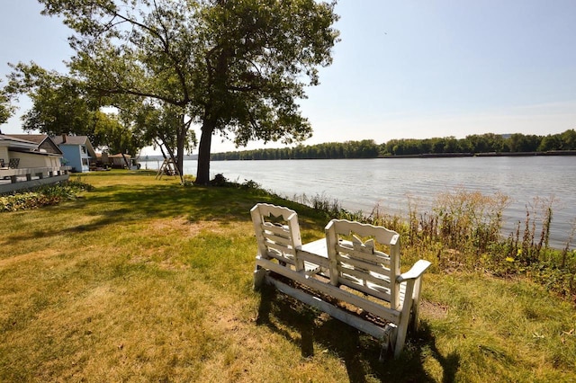 exterior space with a water view and a yard