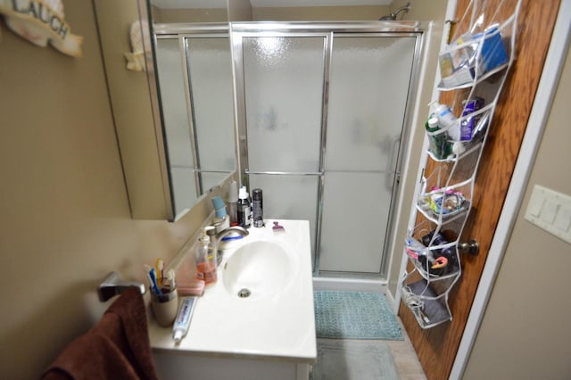 bathroom with a shower stall and vanity