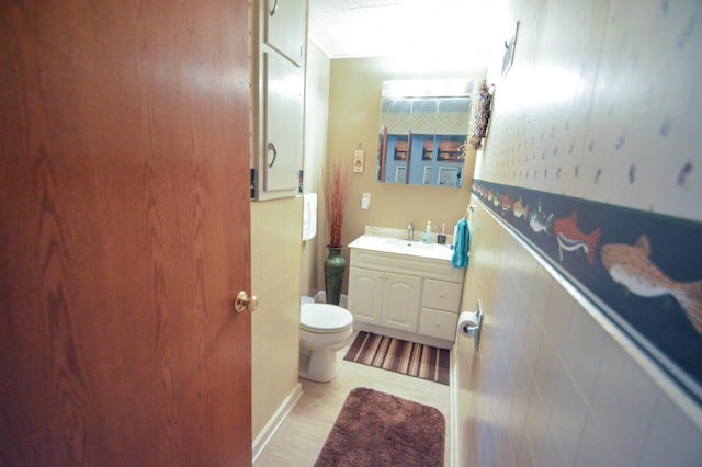 half bathroom with toilet and vanity