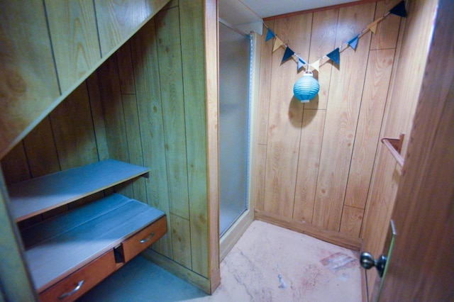 full bathroom with wood walls and a shower stall