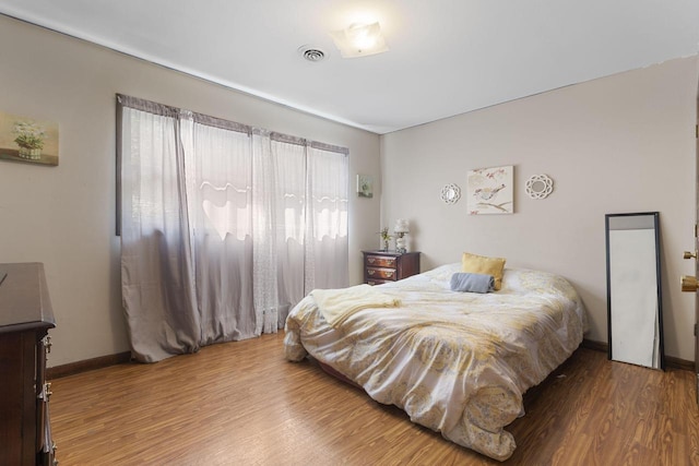 bedroom with wood-type flooring