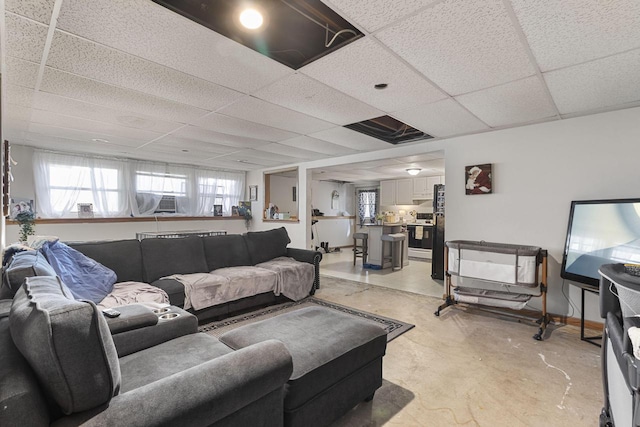 living room with a paneled ceiling