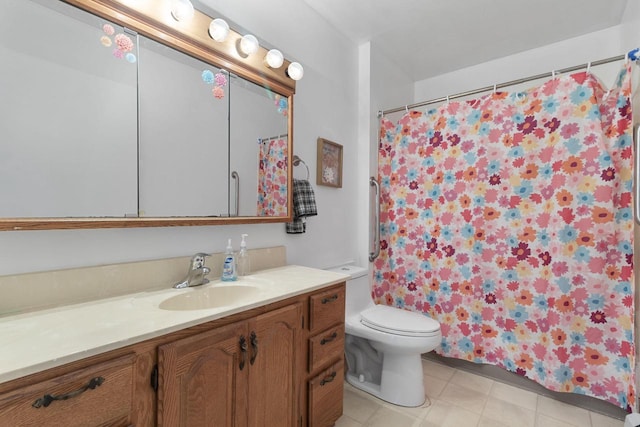 bathroom featuring tile patterned floors, toilet, and vanity