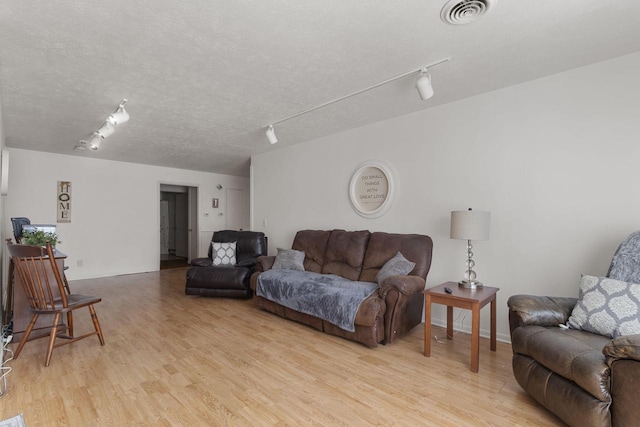 living room featuring track lighting and light hardwood / wood-style flooring