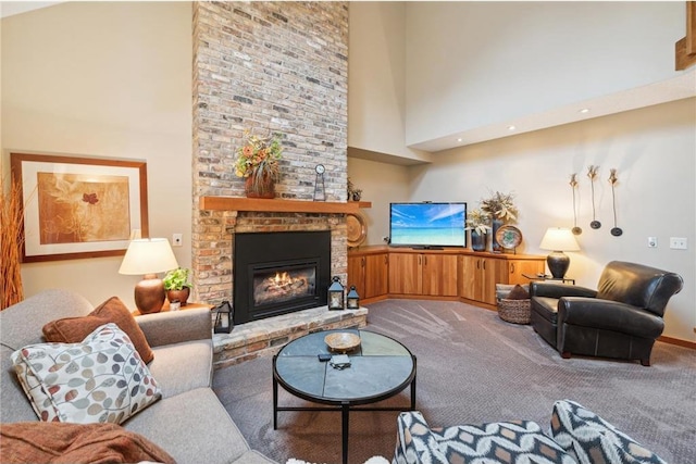 carpeted living room featuring a brick fireplace and a high ceiling