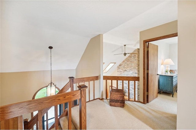 corridor with lofted ceiling and carpet