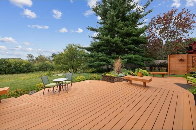 wooden deck featuring a yard