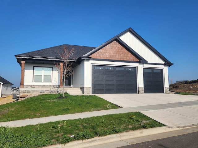 craftsman-style home with a front yard and a garage