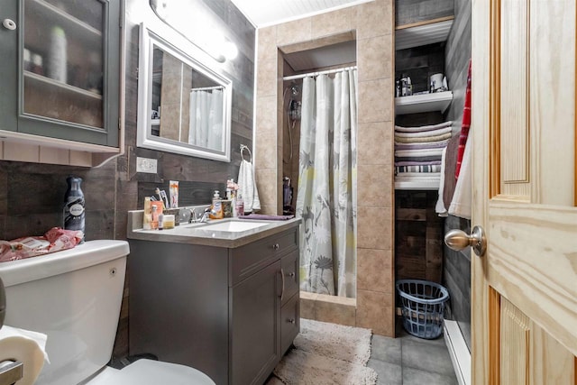 bathroom featuring a stall shower, tile walls, toilet, and vanity