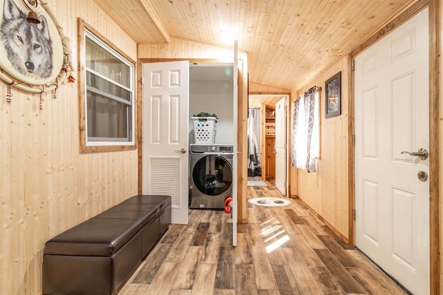 laundry room with wood ceiling, wood walls, wood finished floors, washer / dryer, and laundry area