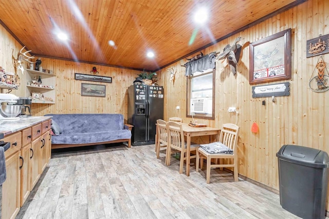 dining room with wood walls, light wood-type flooring, and wood ceiling