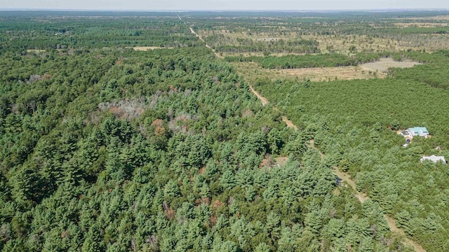 drone / aerial view featuring a wooded view